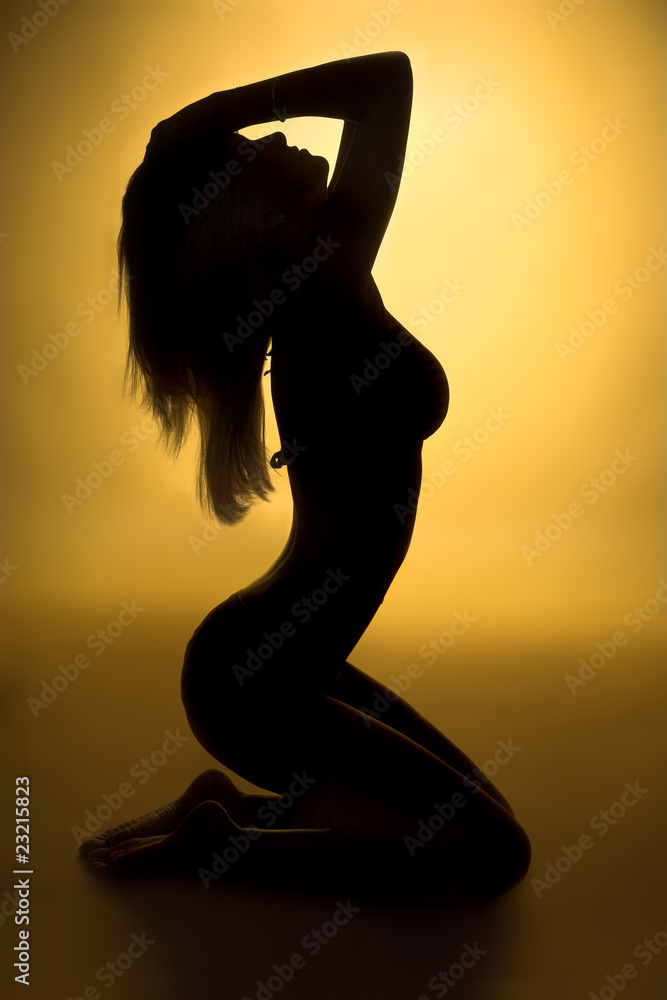 sexy woman silhouette and yellow background - obrazy, fototapety, plakaty 