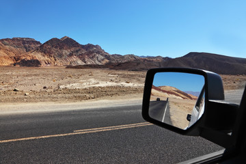 Wall Mural - The  road is reflected in the car mirror