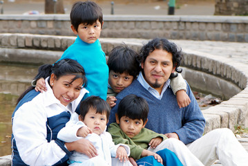 Wall Mural - Latin family sitting in the street