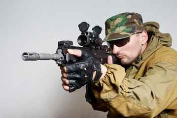 Portrait of  the soldier with an automatic assault rifle