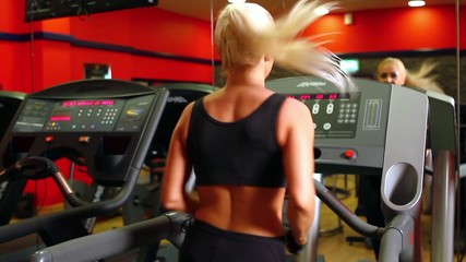 Wall Mural - Beautiful sporty woman is exercising at the gym centre