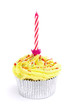 yellow cupcake with candle over white