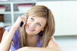 © WavebreakMediaMicro - Cheerful woman talking on the phone in the kitchen