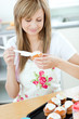 © WavebreakMediaMicro - Portrait of a beautiful woman preparing a cake in the kitchen