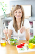 © WavebreakMediaMicro - Cute woman preparing a salad in the kitchen
