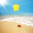 Yellow T shirt hung on a line on beach