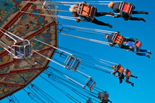 Action Photo Of Carousel On Blue Sky