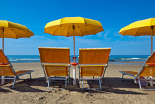 Lounge Chairs Under A Yellow Umbrella