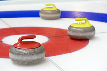 Group Of Curling Rocks On Ice