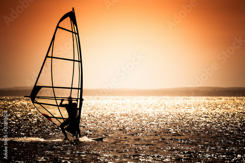 Naklejka ścienna windsurfer silhouette on a sunset background