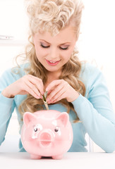 Canvas Print - lovely woman with piggy bank and money