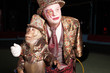Circus clown with a monkey.