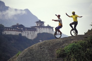 Unicyclists Riding Down Hill