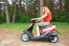 Woman Driving A Scooter