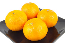 Four Oranges On Plate On White Background