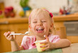 little girl eating yoghurt