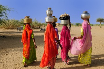 Ethnic women going for the water in well on the desert