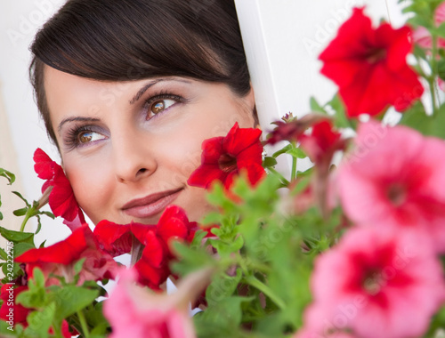 Fotografie, Obraz Portrait of the beautiful bride among red flowers