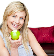 Wall Mural - Joyful woman eating an apple