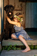 Portrait of beautifull girl and her black dog.