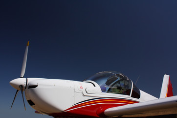 Motorsegler in Weiss-Rot-Blau vor blauem Himmel