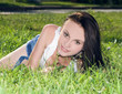 © Aleksandr Kurganov - Cute young female lying on grass field at the park