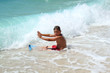 © ArtushFoto - small boy sitting and stopping waves on sea