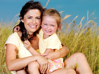 Wall Mural - Happy mother and little daughter on nature