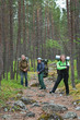 © Kekyalyaynen - Group of travelers trekking in forest with knapsacks