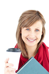 Canvas Print - Cheerful caucasian woman holding a book and coffee