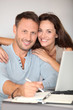 © goodluz - Couple at home surfing on internet