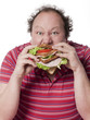 homme obese mangeant un sandwich