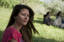 Girl Sitting Listening Outdoor Grass