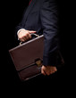 © Gresei - business person holding a briefcase