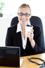 Poster - Delighted caucasian businesswoman holding a coffee smiling at th