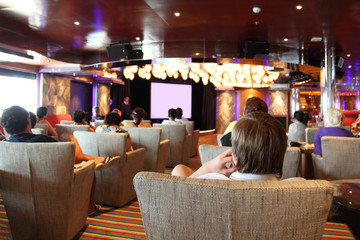 group of people at cruise liner cinema looking at screen