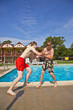 © travelview - brothers having fun at the pool