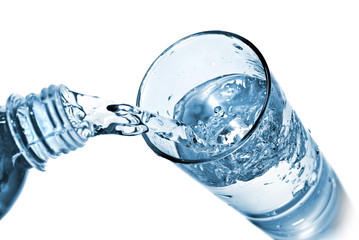 Wall Mural - water pouring into glass isolated on white