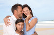 © goodluz - Portrait of happy family at the beach