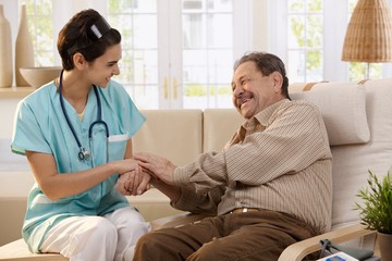 Happy nurse and elderly patient.