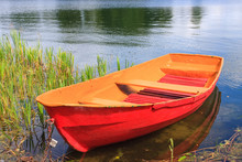 Red Rowing Boat On Lake