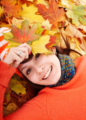 Wall Mural - young woman in autumn orange leaves.