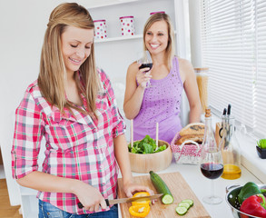 Wall Mural - Two positive women cooking together at home