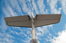 Large Aircraft Tail Fin Against A Blue Cloudy Sky