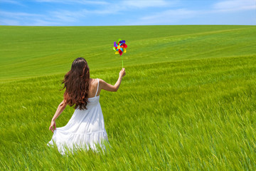 girl in a green field, enjoying nature