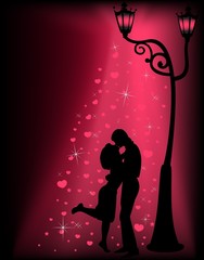 Silhouettes of two lovers under a lantern