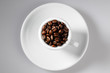 Coffee beans in withe cup top view