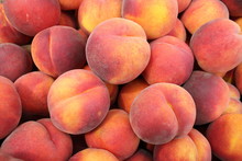 Peaches In A Pile At A Farmer's Market