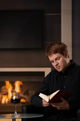 Wall Mural - Young man reading book