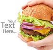 big cheeseburger held in hands with space for text